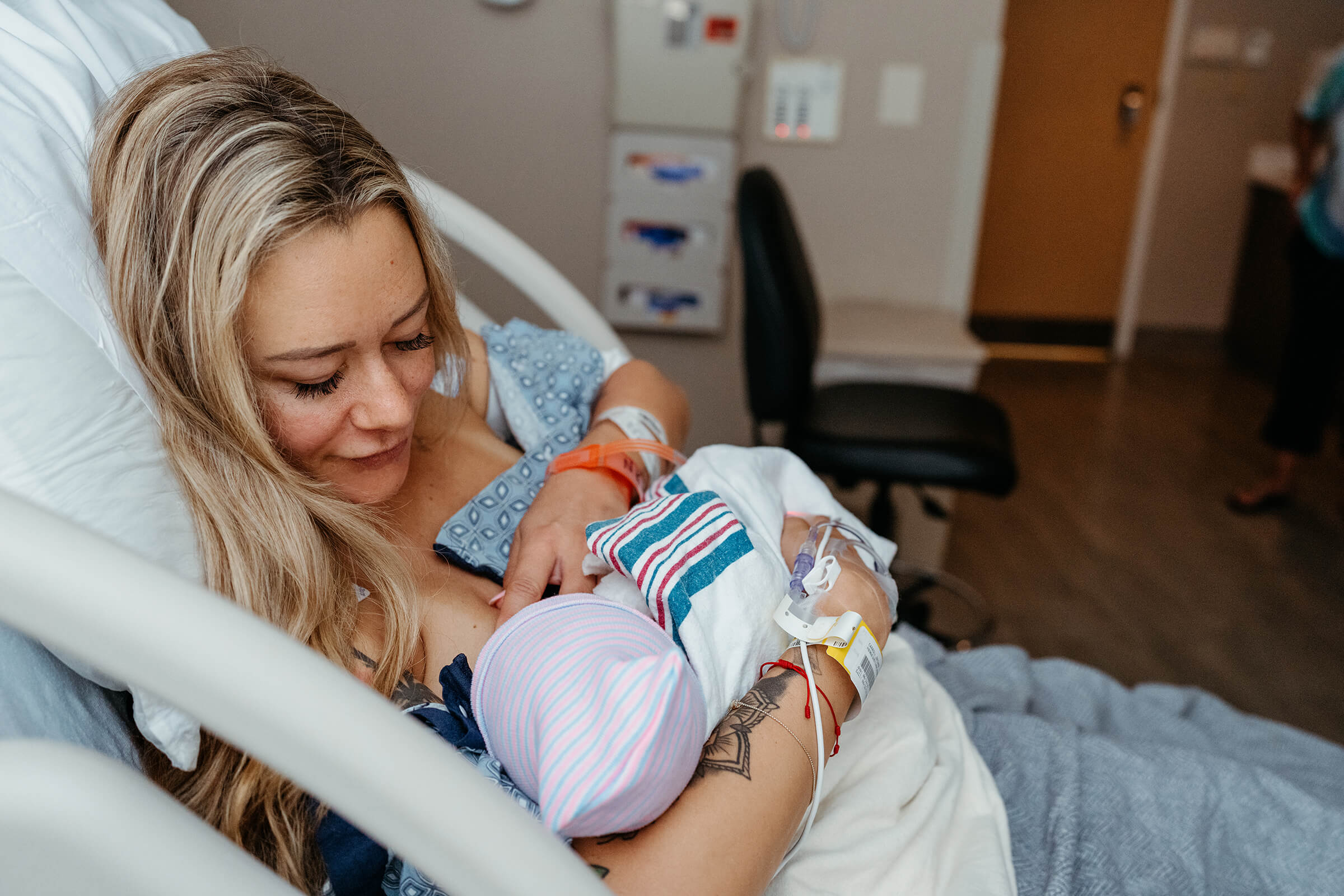 woman breastfeeding after a c-section in the hospital setting