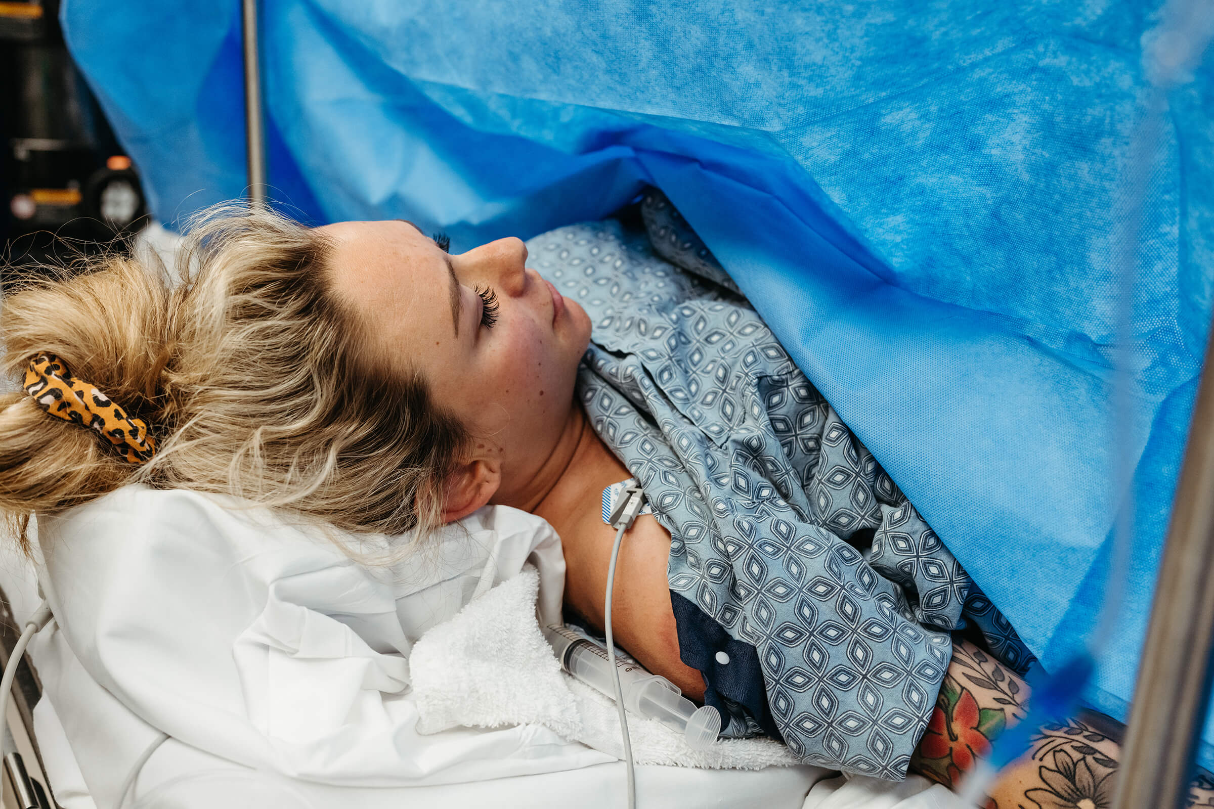 mother lying on operating room table during a cesarean 