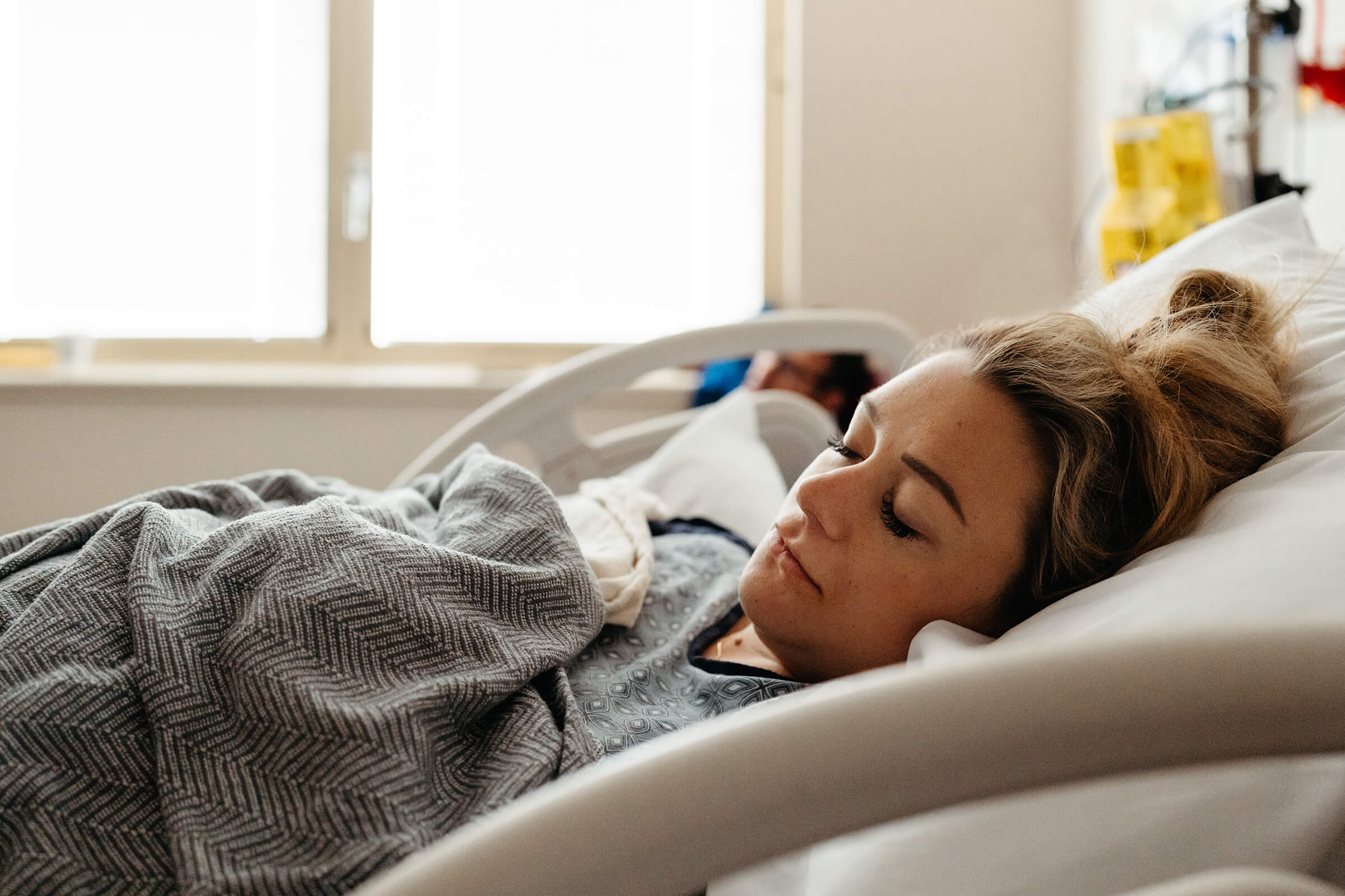 sleeping in a hospital bed after getting an epidural in labor 