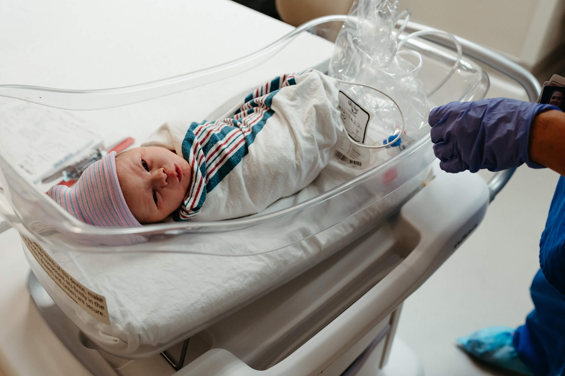 baby being brought back to the room after a c-section delivery