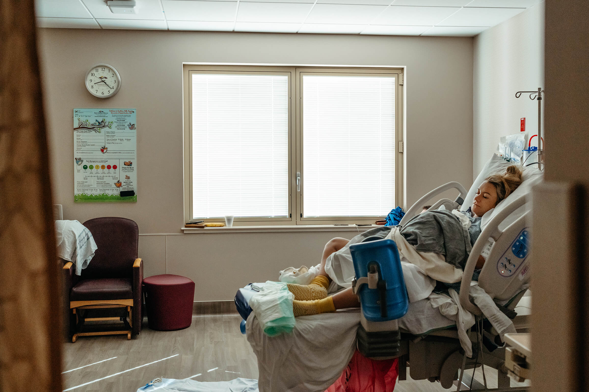 mother resting in hospital bed after epidural placement