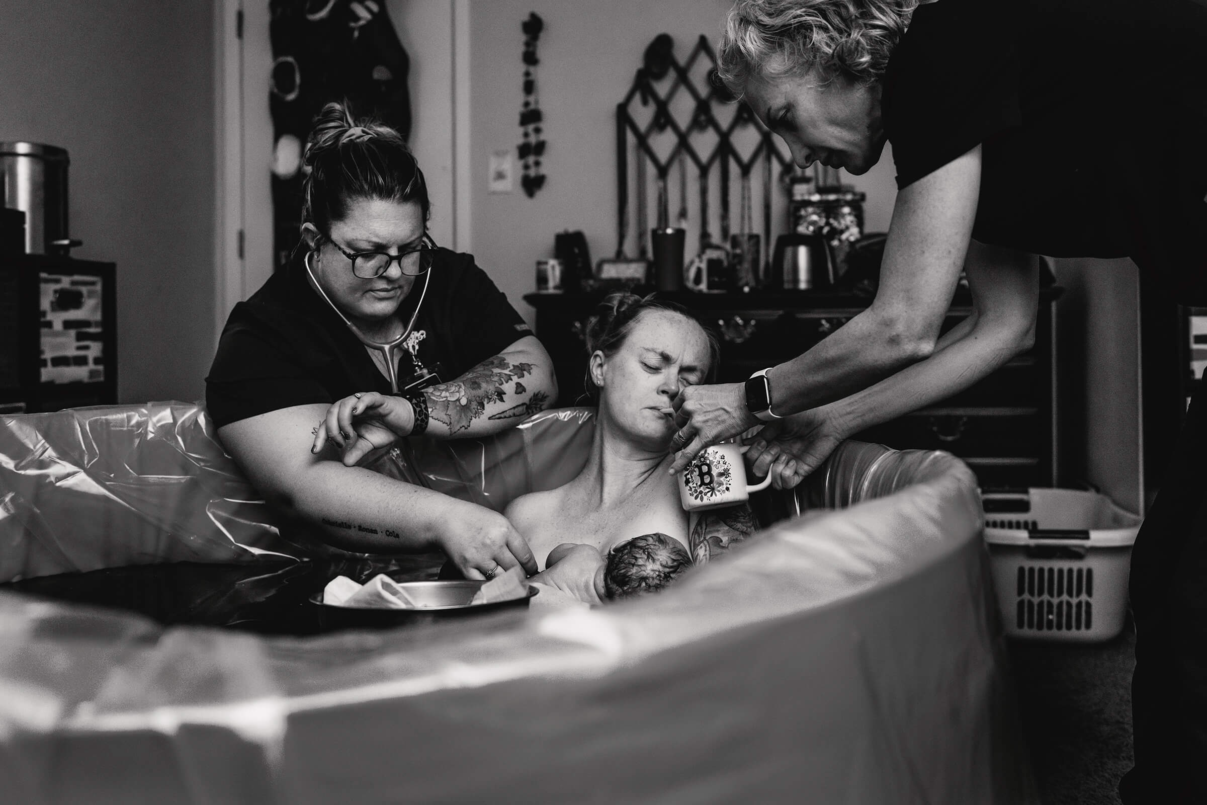 midwives checking vital signs of a mother while she breastfeeds