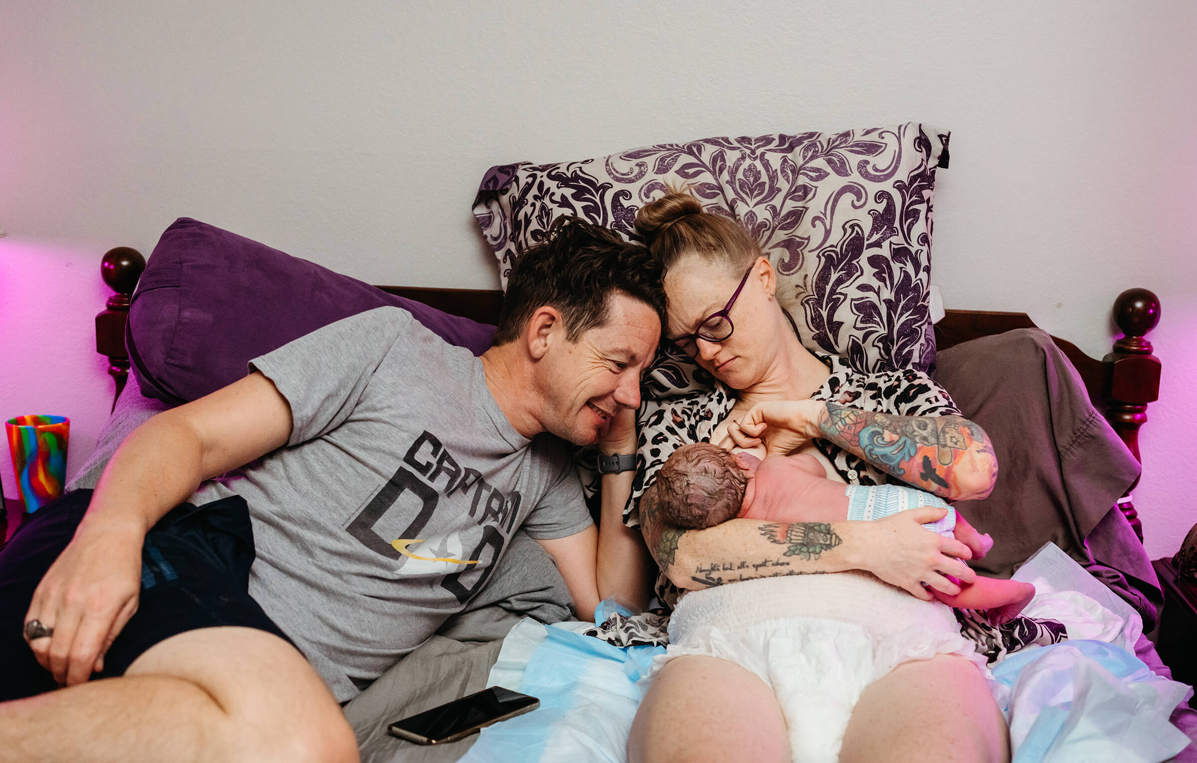 parents in bed at home with the new baby after a successful home birth in Las Vegas