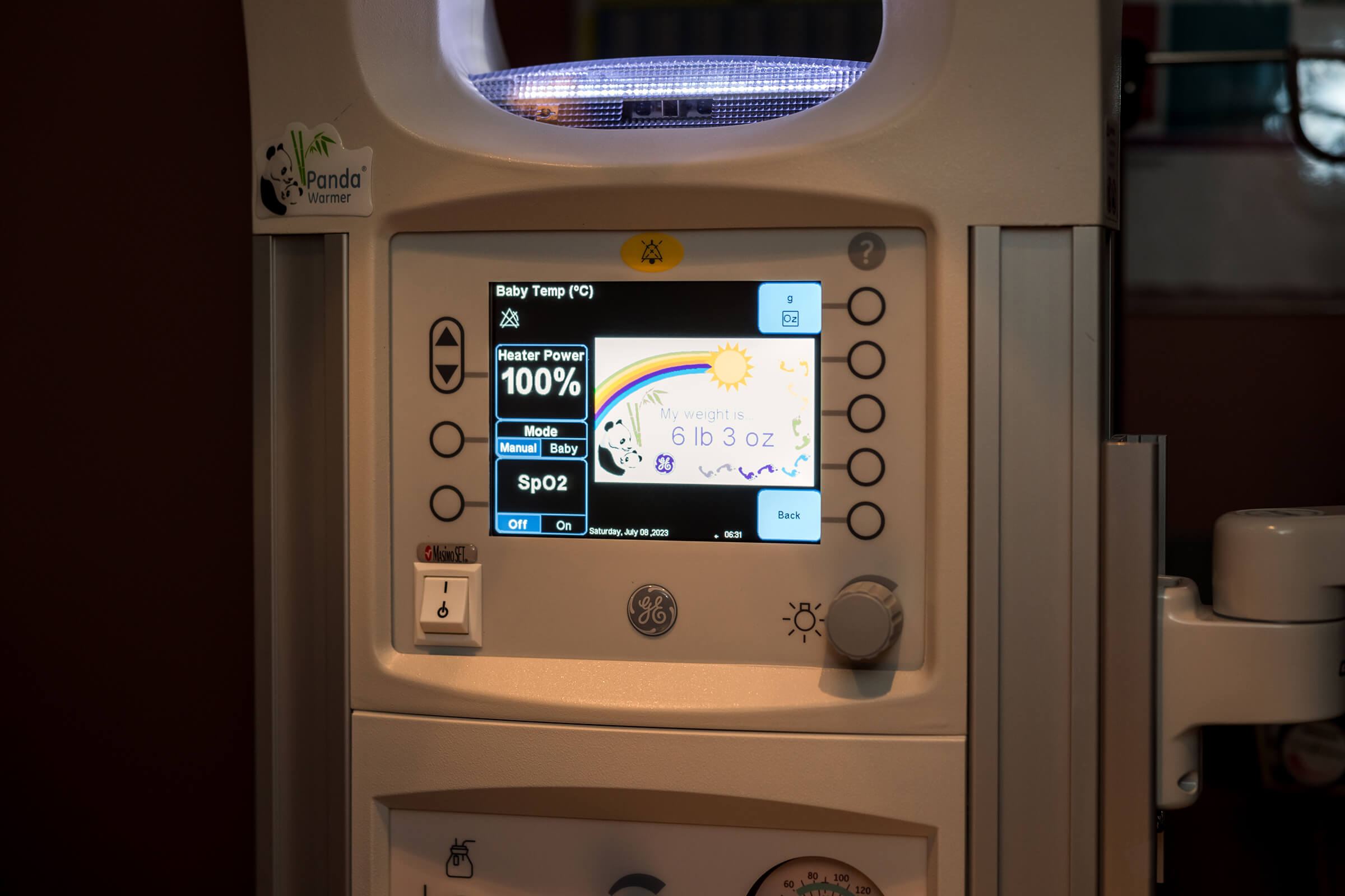 newborn's weight displayed on a warmer in the hospital setting.