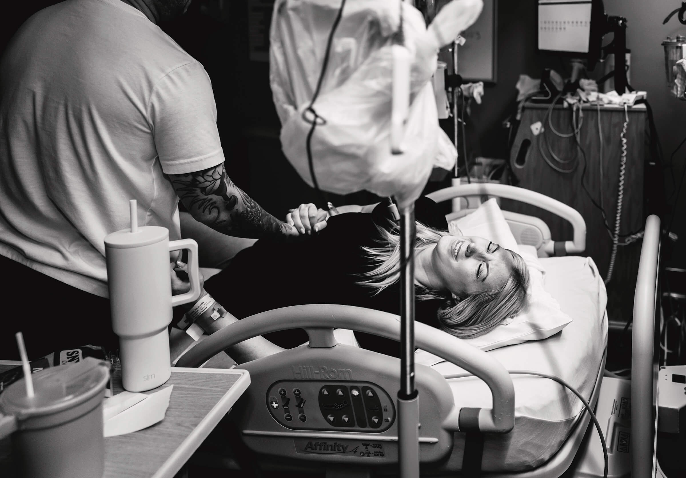 a woman breathing through contractions as she has the urge to push while waiting for the doctor