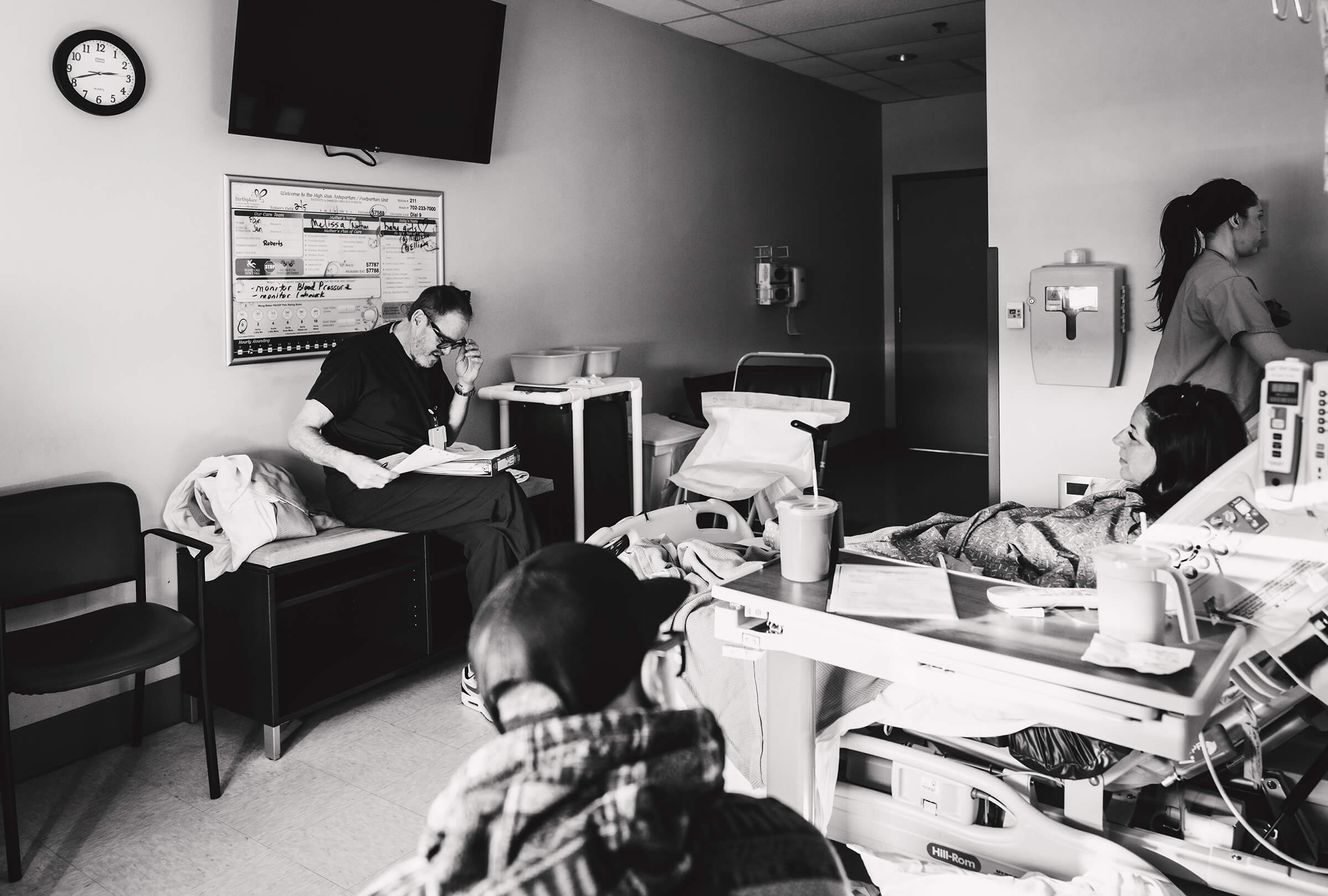 Dr. Paul Wilkes visits his patient while they prepare for a c-section for twins.