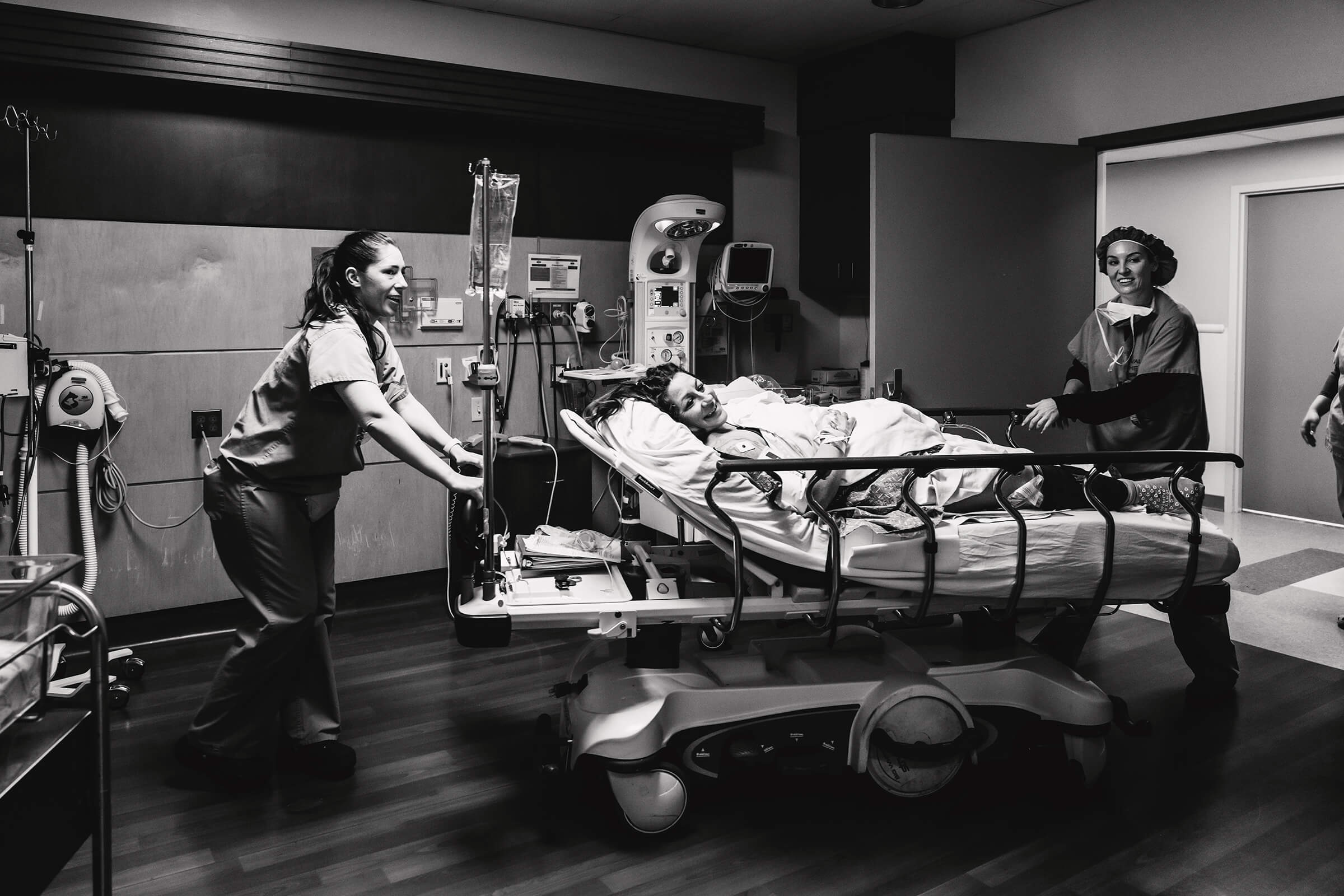 mother being wheeled back in the recovery room after surgery