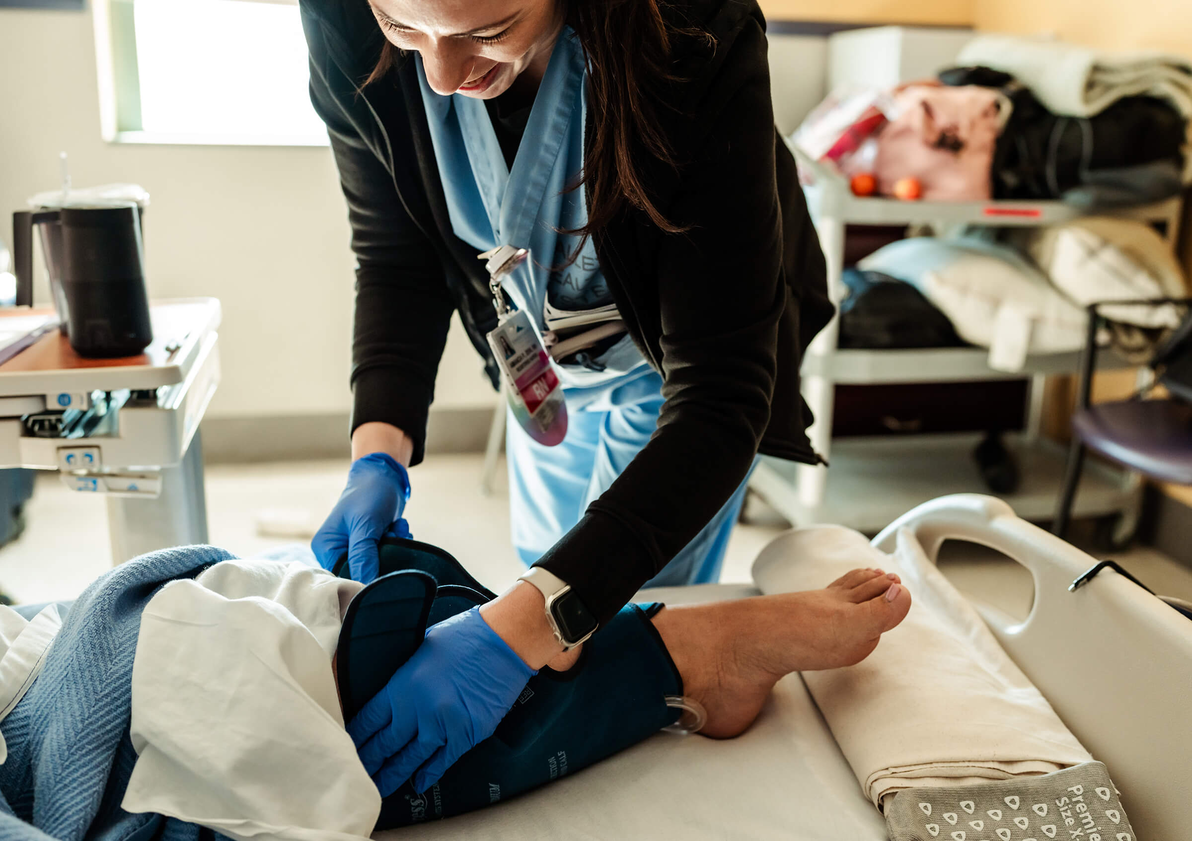 compression stockings being applied by a labor and delivery nurse before a schedule cesarean section