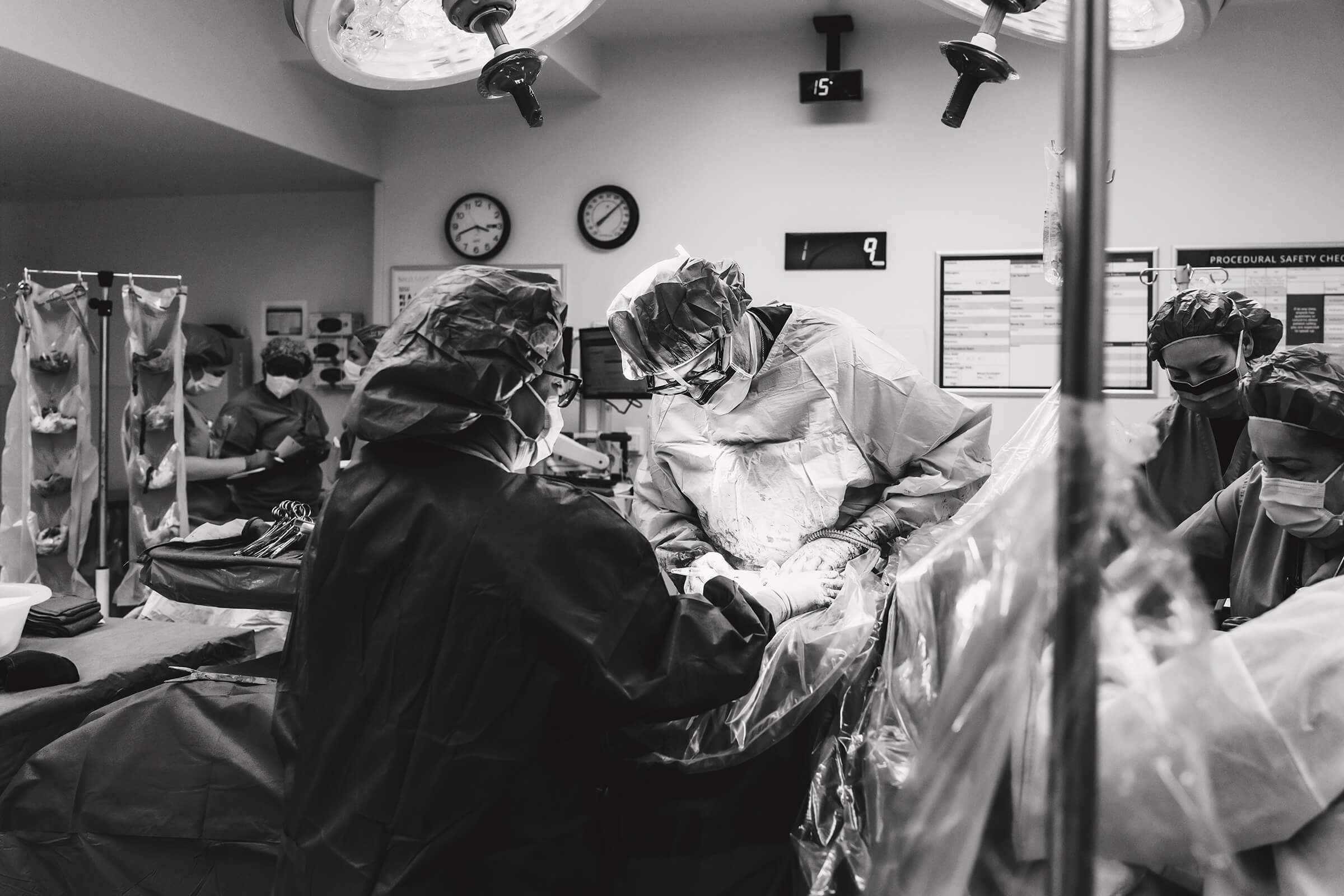 Dr Wilkes closing after a c-section with assistance from the OB tech