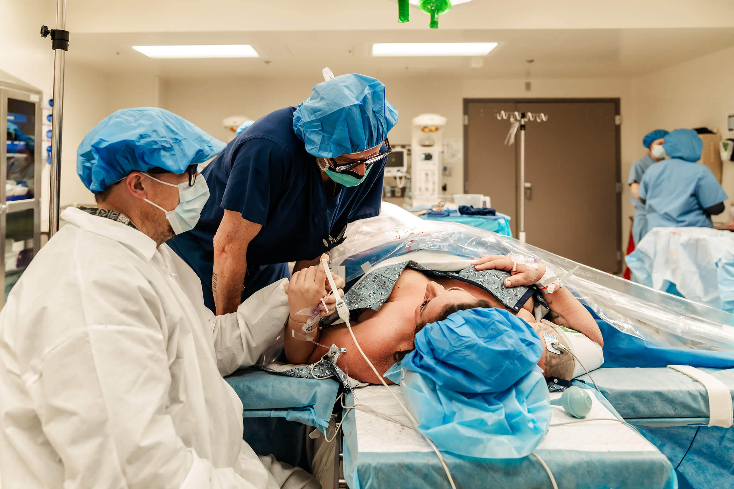 Dr Wilkes talking to his patient after performing a gentle cesarean for their twin girls. 