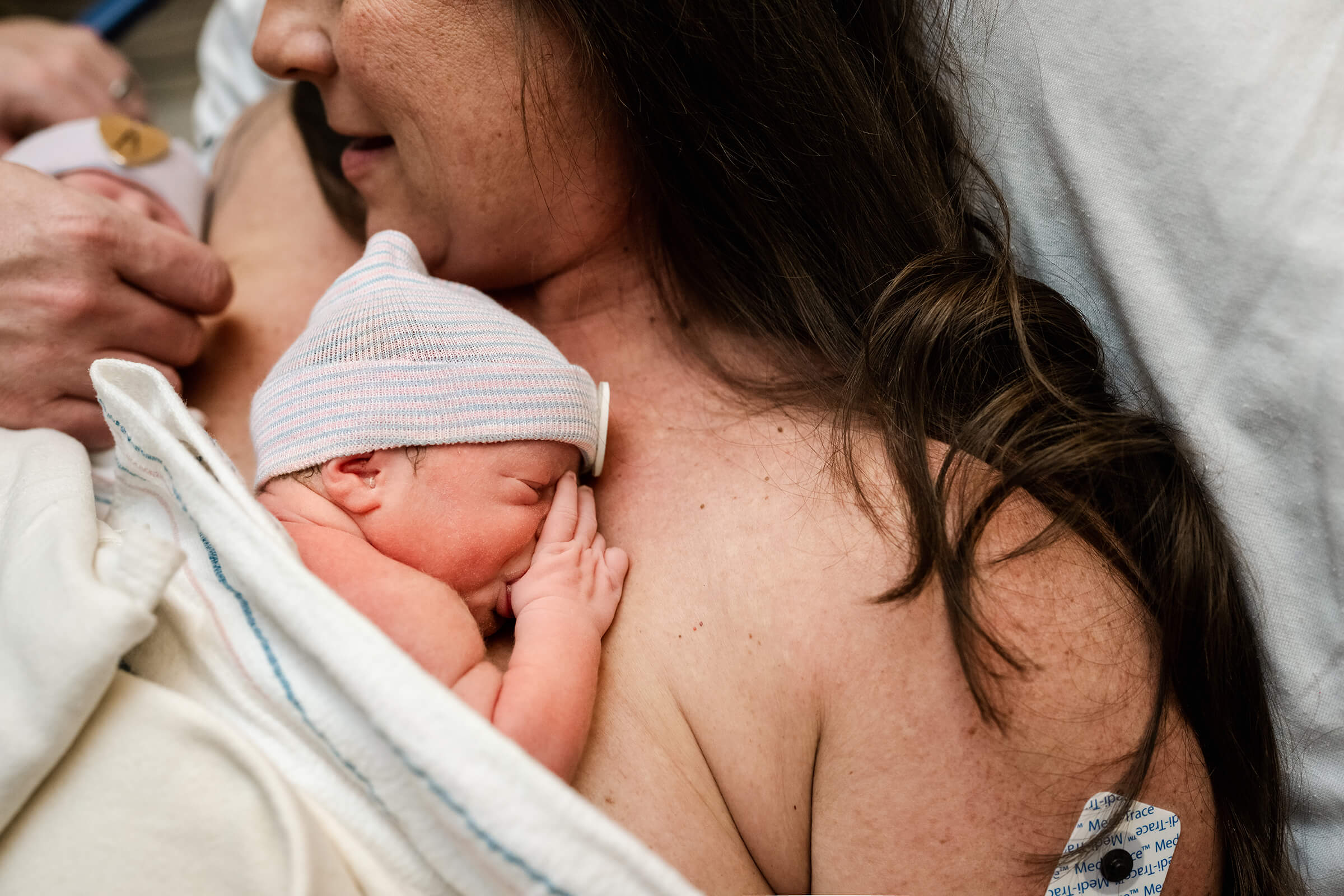 newborn sucking her thumb right after delivery