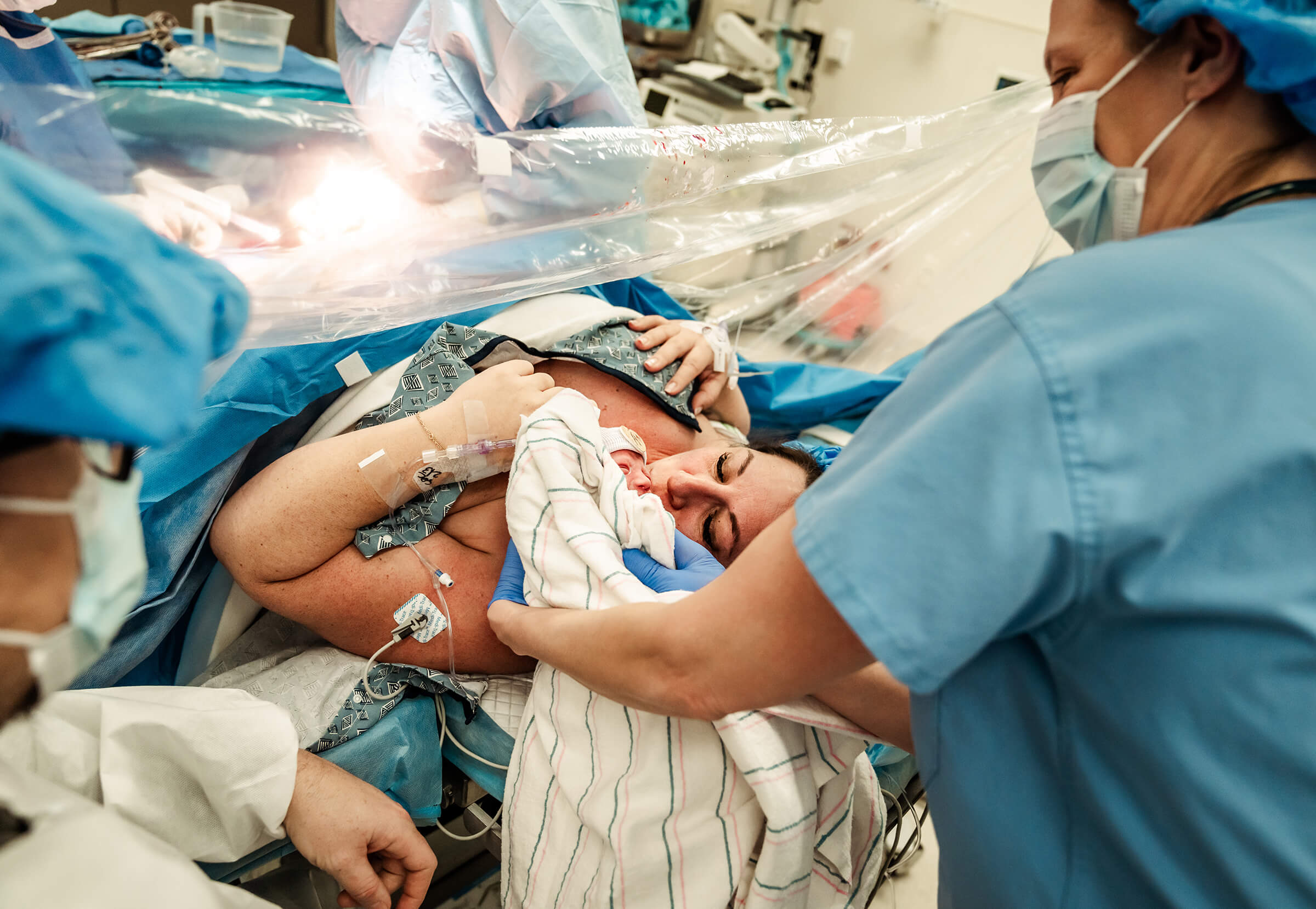 Nurse brings baby to mother after cesarean for bonding