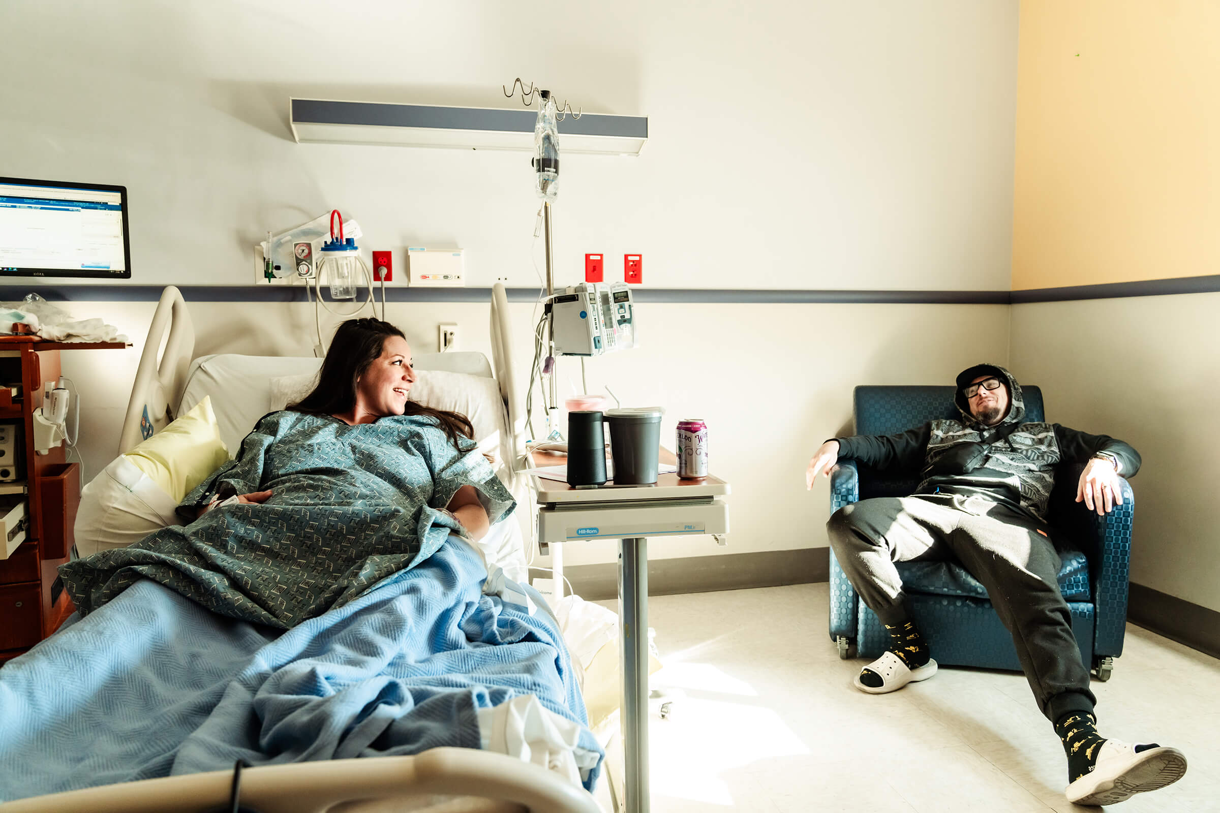 parents enjoy laughs together as they prepare to welcome their twin girls via c-section