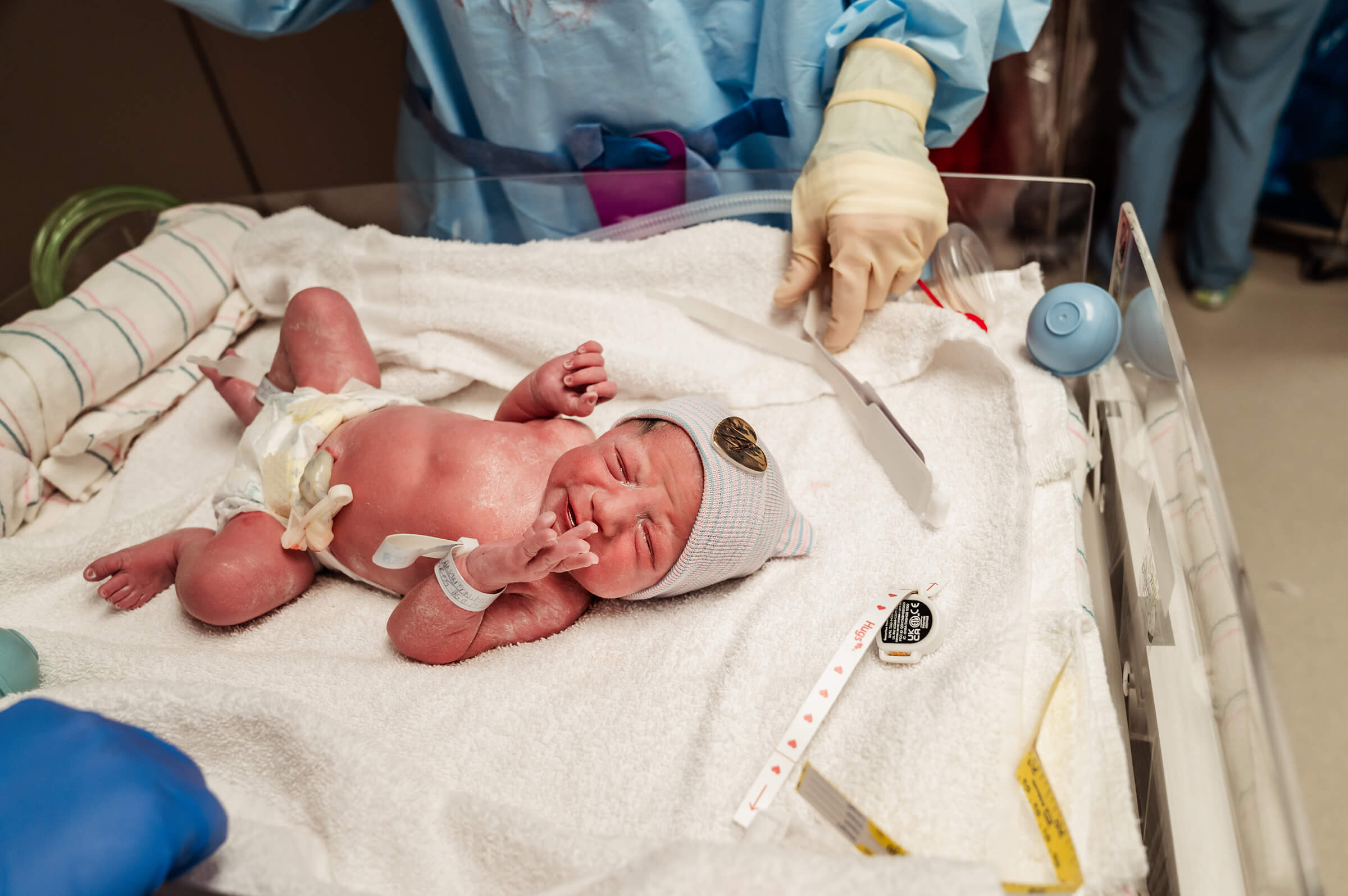 baby under radiant warmer in the operating room after delivery