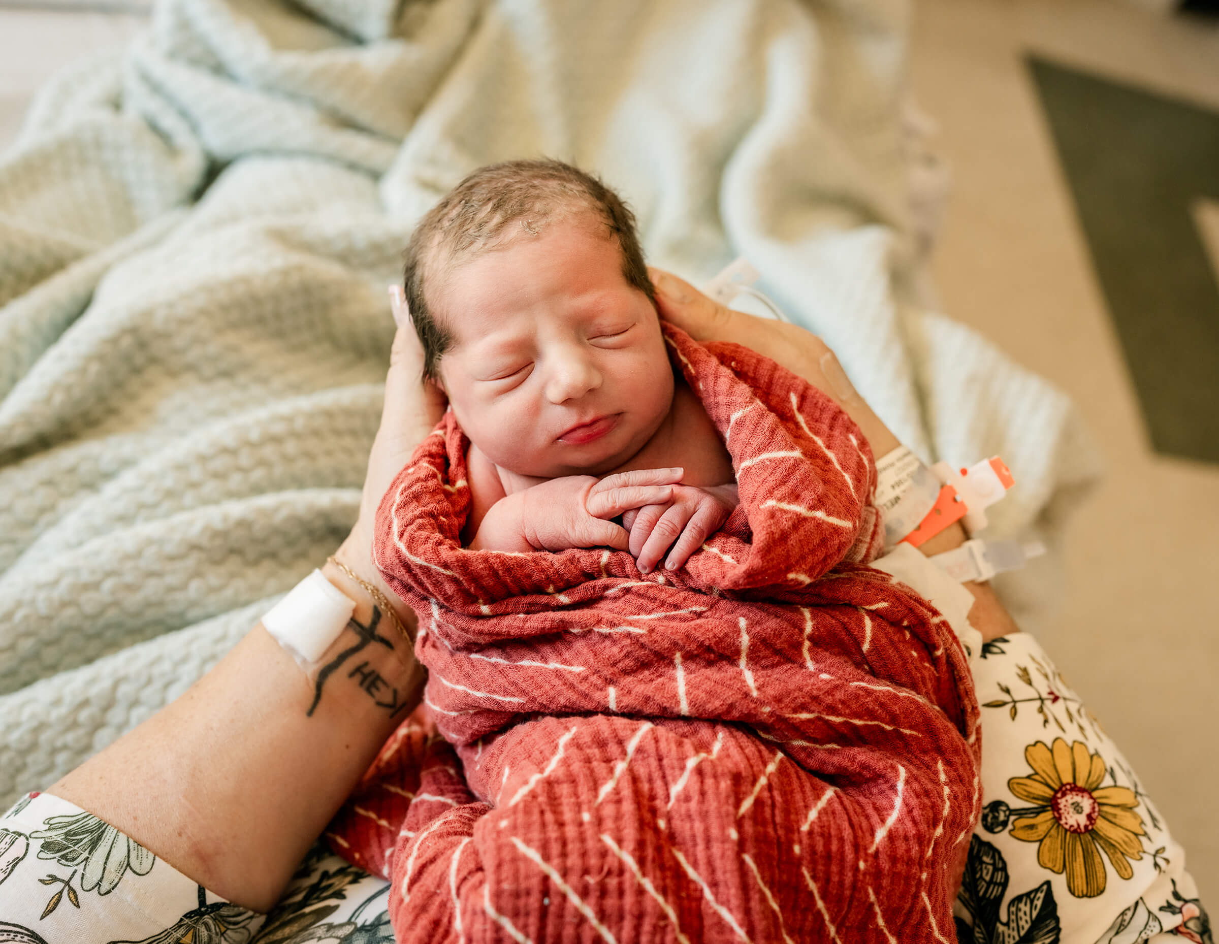 mother holding her new daughter in the hospital bed