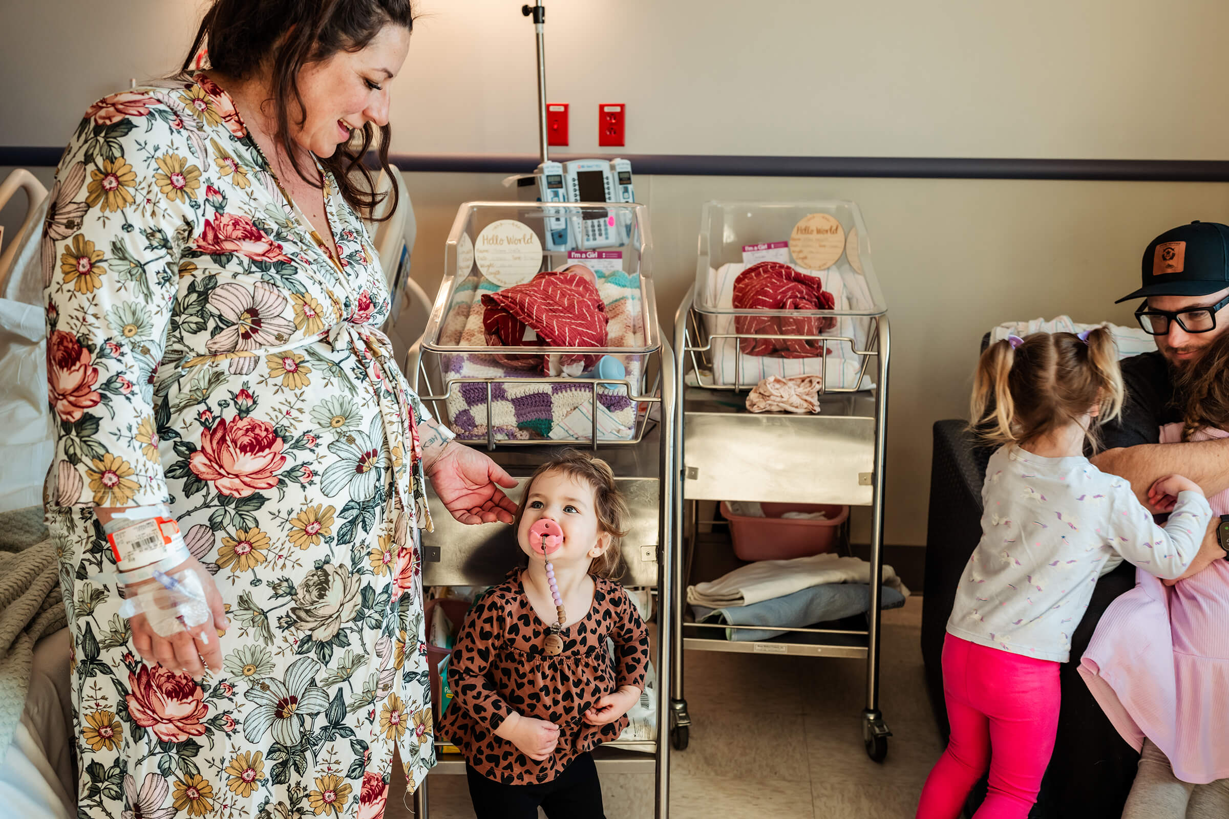 mom helping her daughters prepare to meet their baby sisters
